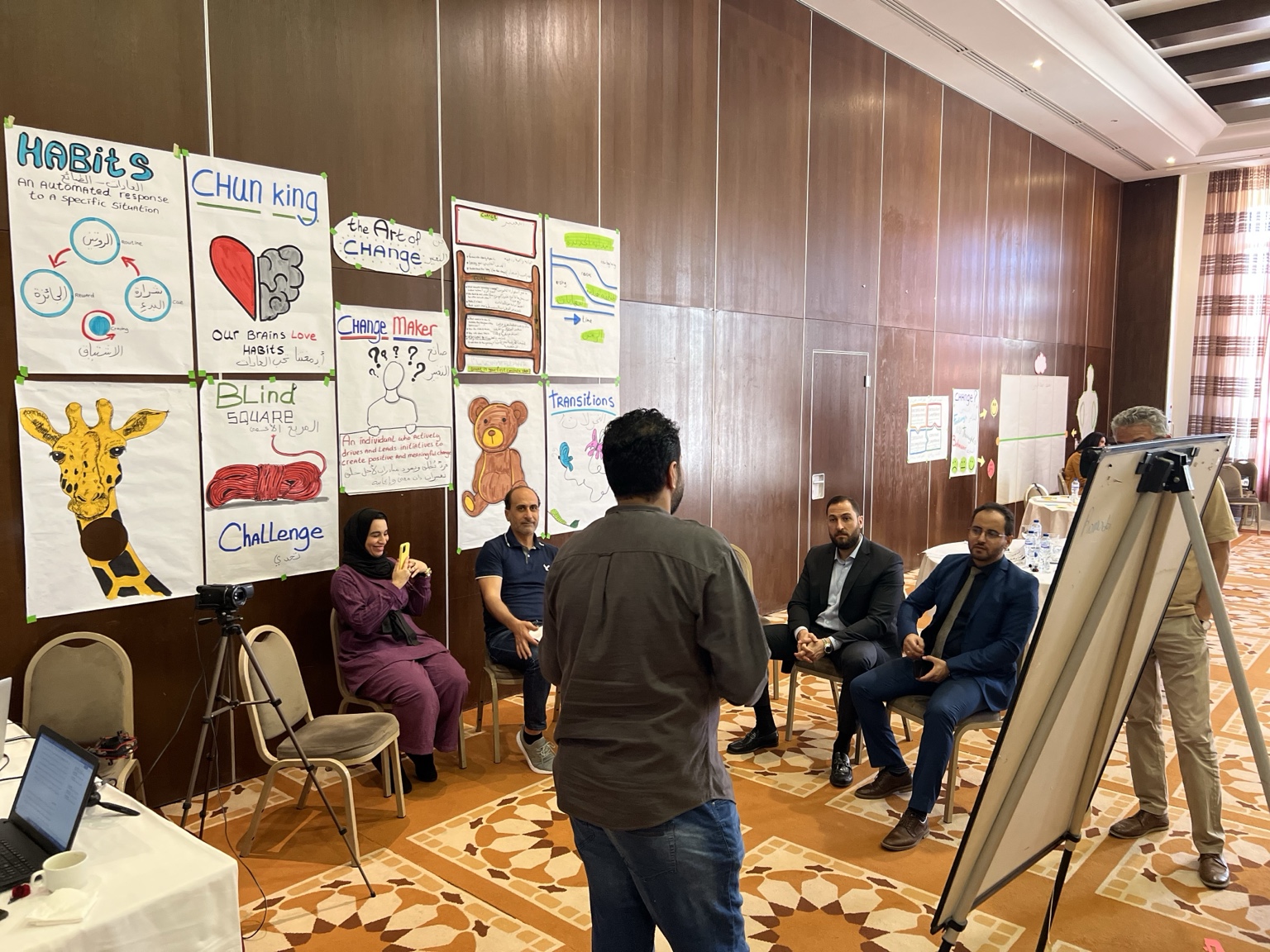 Participants gathered around visual learning materials